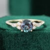 Round Cut Alexandrite Gold Engagement Ring with Diamond Cluster Accents