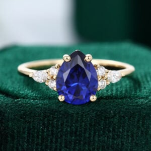 Classic Pear Cut Gold Sapphire Engagement Ring with Diamond Cluster