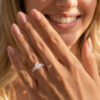 A Woman Wears a Oval Cut Moissanite Bridal Ring Set with Classic Straight Band