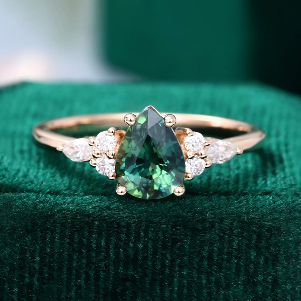 https://mollyjewelryus.com/wp-content/uploads/2022/10/Oval-Cut-Green-Sapphire-Engagement-Ring-Set-with-Moissanite-Accent-Stones-5.jpg?utm_source=chatgpt.com