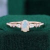 Oval cut facet opal engagement ring trio side stones promise ring