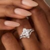 A Woman is Showing Off a Marquise Cut Moissanite Engagement Ring Set