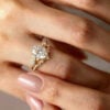A 2CT Oval Cut Nature Inspired Moissanite Bridal Ring Set on the Hand