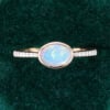 East-West Oval Cut Natural Opal Engagement Ring With Half Eternity Pavé Band (1)