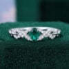 Oval Cut Emerald Engagement Ring With Interlock Crossover Band (1)