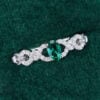 Oval Cut Emerald Engagement Ring With Interlock Crossover Band (12)