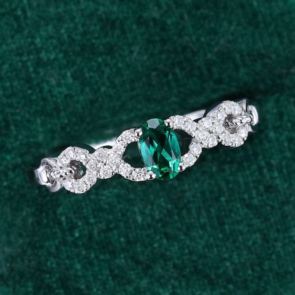 Oval Cut Emerald Engagement Ring With Interlock Crossover Band (12)