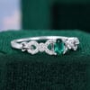 Oval Cut Emerald Engagement Ring With Interlock Crossover Band (9)