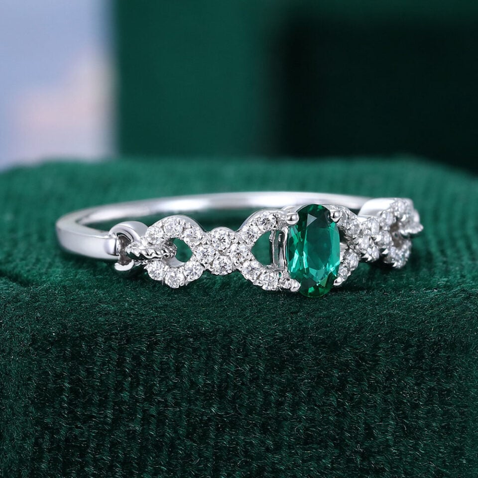 Oval Cut Emerald Engagement Ring With Interlock Crossover Band (9)