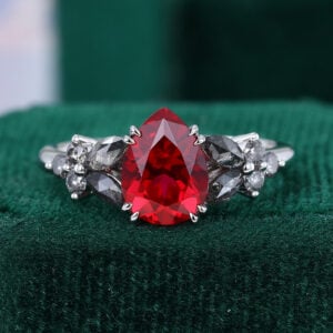 Blossom Cluster | Gothic Inspired Pear Cut Ruby Engagement Ring with Speckled Diamond Accents