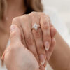 A Woman is Showing Off a Marquise Cut Moissanite Halo Engagement Ring with Hidden Detail