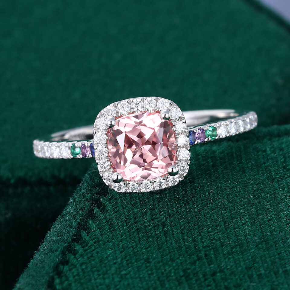 Cushion cut pink sapphire halo engagement ring with half eternity pavé band