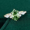 Oval cut lab green diamond engagement ring with classic cluster accents