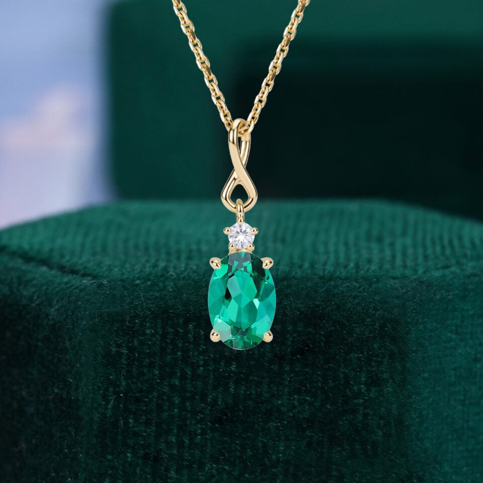 Oval Cut Emerald Infinity Pendant Necklace with Diamond Accents