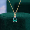 Pear cut emerald infinity solitaire pendant necklace