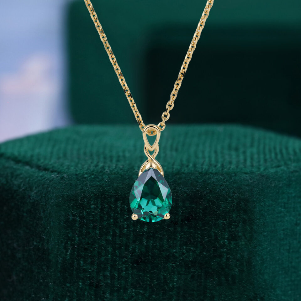 Pear cut emerald infinity solitaire pendant necklace
