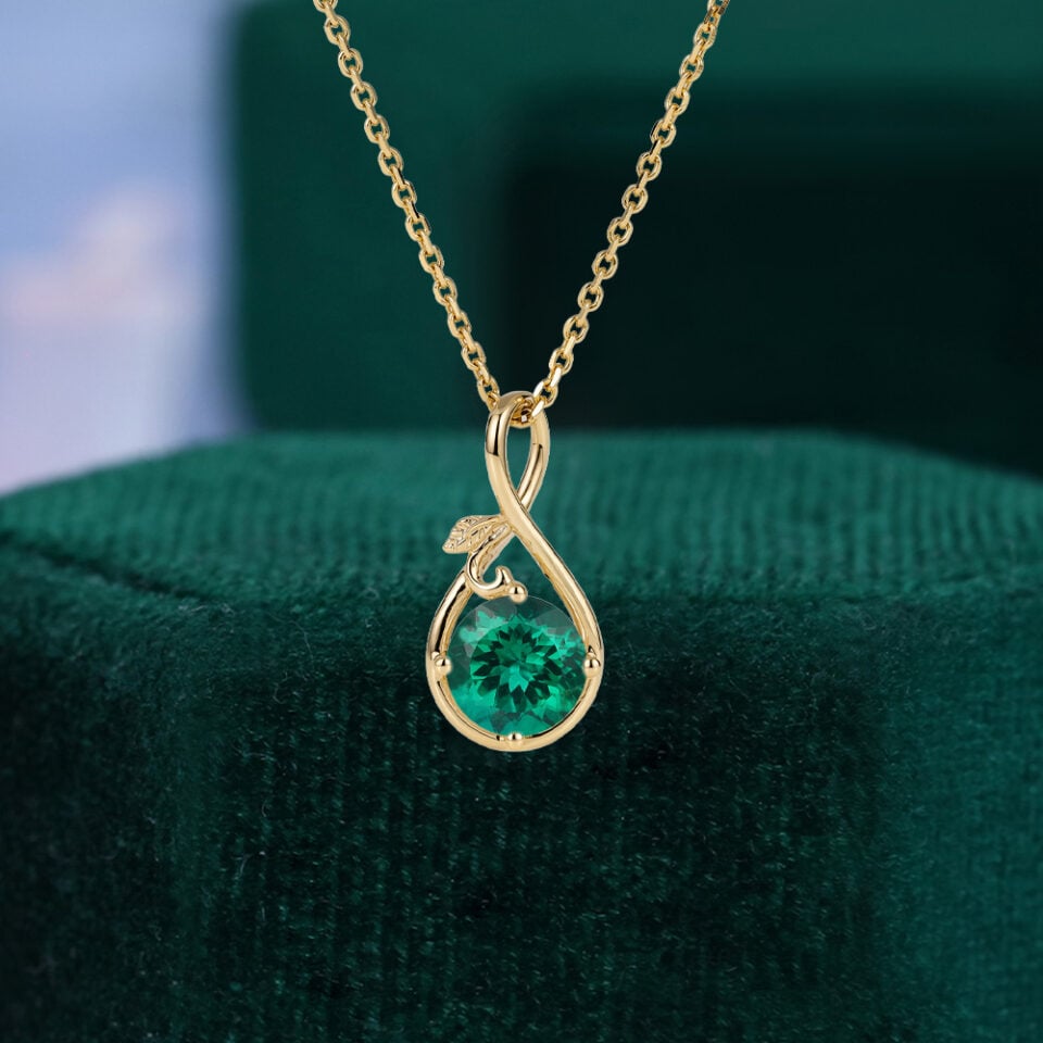 Round Cut Emerald Infinity Pendant Necklace With Leaf Accents