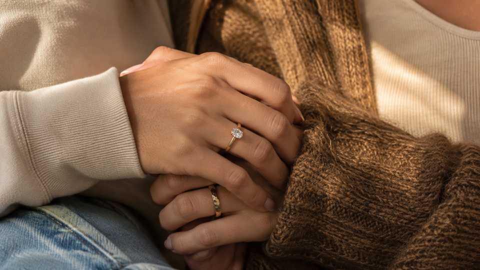 Two women showing complementary affordable WLW engagement rings