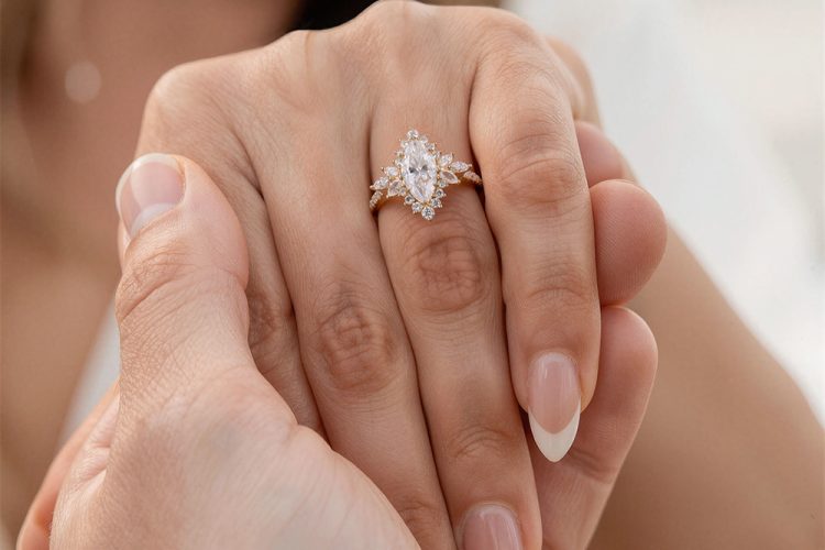 A Woman is Showing Off a Marquise Cut Moissanite Halo Engagement Ring with Hidden Detail